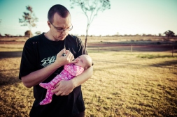 Baby Aria's dad John comforts her at the end of a photoshoot on the outskirts of Kalgoorlie.